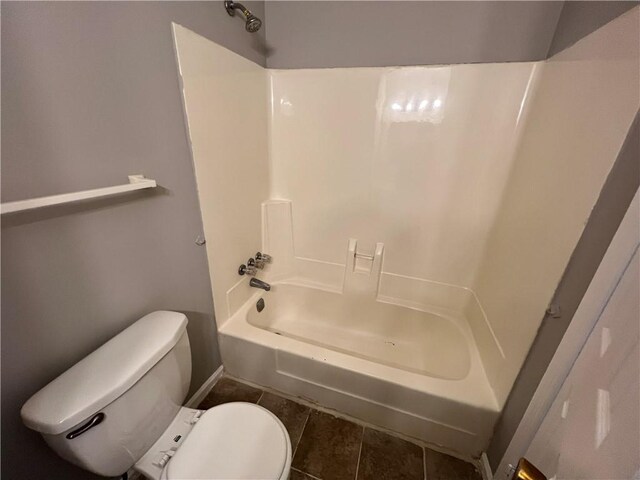 bathroom with toilet, shower / bathing tub combination, and tile patterned floors