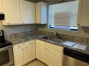 kitchen featuring dark stone countertops, sink, white cabinets, and appliances with stainless steel finishes