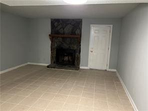 unfurnished living room with a large fireplace