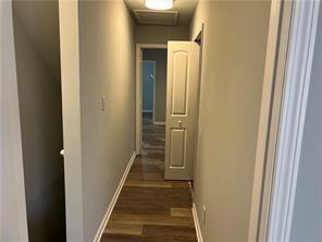 corridor featuring dark hardwood / wood-style flooring