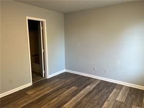 empty room with dark hardwood / wood-style floors