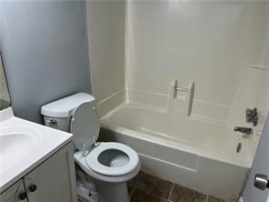 full bathroom featuring vanity, shower / bath combination, and toilet