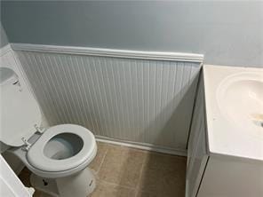 bathroom with tile patterned flooring, vanity, and toilet