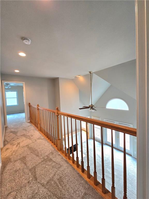 unfurnished bedroom featuring a ceiling fan, visible vents, light carpet, and baseboards