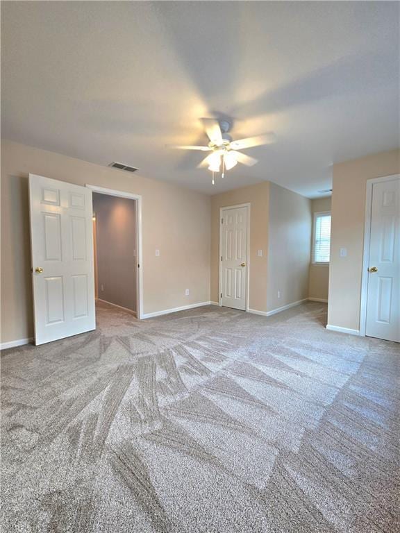 bathroom featuring baseboards, visible vents, and double vanity