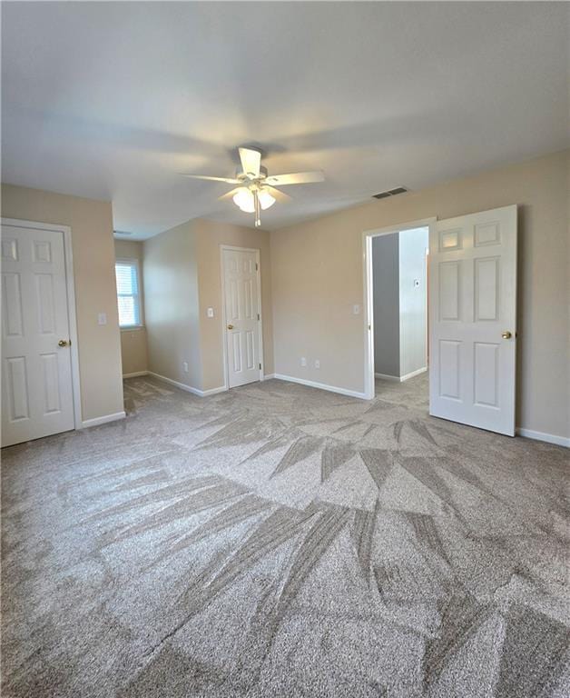 unfinished basement featuring stairway and water heater