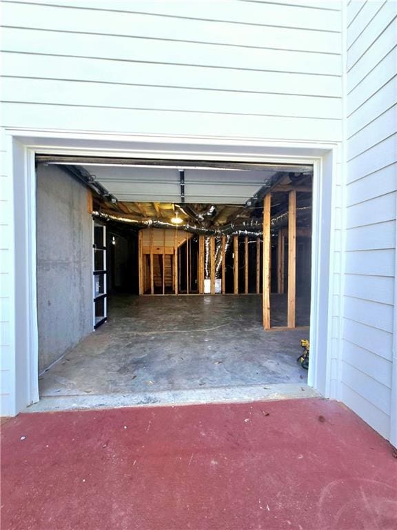 view of property exterior featuring driveway, a garage, and central AC
