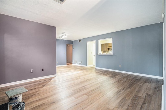 empty room with light hardwood / wood-style floors