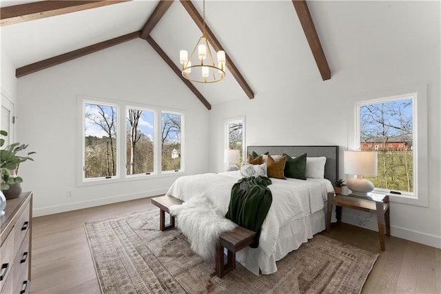 bedroom with multiple windows, high vaulted ceiling, and light wood-style floors