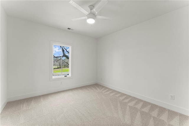 unfurnished room with baseboards, visible vents, and light carpet