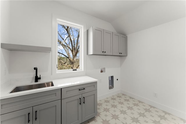 washroom featuring light floors, washer hookup, cabinet space, hookup for an electric dryer, and a sink