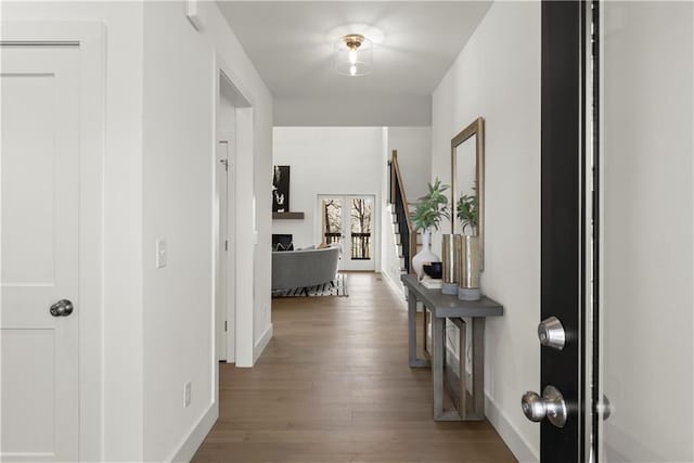 hall with wood finished floors and baseboards