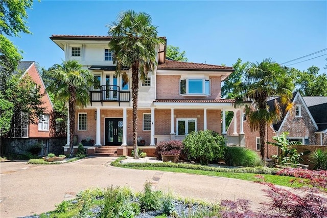 1216 E Rock Springs Rd NE, Atlanta, GA 30306 - view of front of house with french doors, a balcony, brick siding, and covered porch