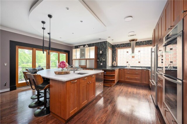 1216 E Rock Springs Rd NE, Atlanta, GA 30306 - kitchen with a sink, brown cabinetry, crown molding, and dark wood-type flooring