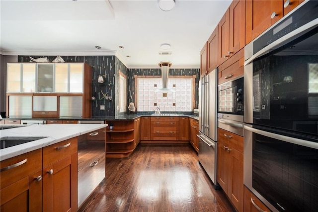 1216 E Rock Springs Rd NE, Atlanta, GA 30306 - kitchen with appliances with stainless steel finishes, light stone counters, brown cabinetry, ornamental molding, and dark wood-type flooring