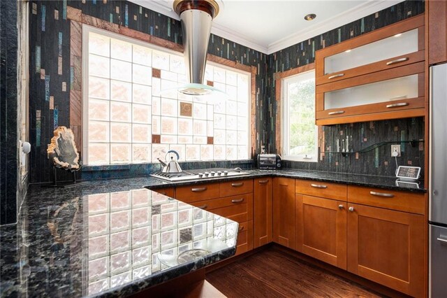 1216 E Rock Springs Rd NE, Atlanta, GA 30306 - kitchen with brown cabinetry, ornamental molding, dark stone countertops, dark wood-style floors, and stainless steel gas stovetop