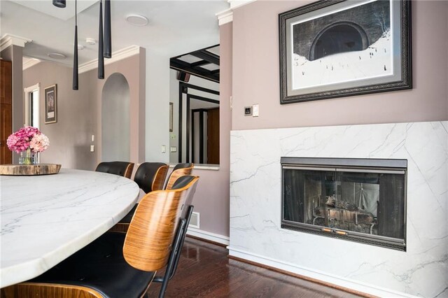 1216 E Rock Springs Rd NE, Atlanta, GA 30306 - dining room featuring wood finished floors, baseboards, a high end fireplace, and arched walkways