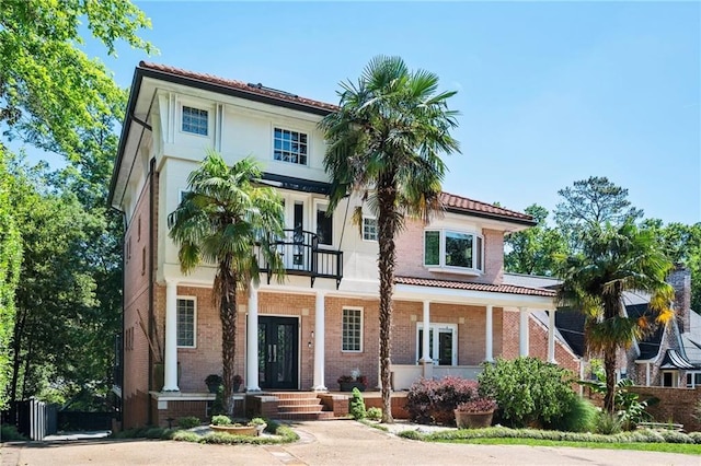 1216 E Rock Springs Rd NE, Atlanta, GA 30306 - mediterranean / spanish house with brick siding, a balcony, and a porch
