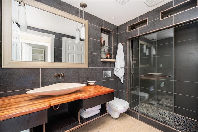 1216 E Rock Springs Rd NE, Atlanta, GA 30306 - full bathroom with a stall shower, tile walls, toilet, vanity, and decorative backsplash