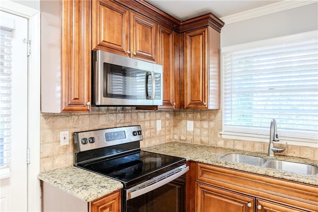 kitchen featuring backsplash, stainless steel appliances, ornamental molding, and sink