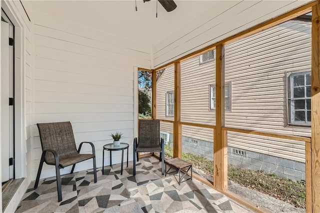 sunroom / solarium featuring ceiling fan