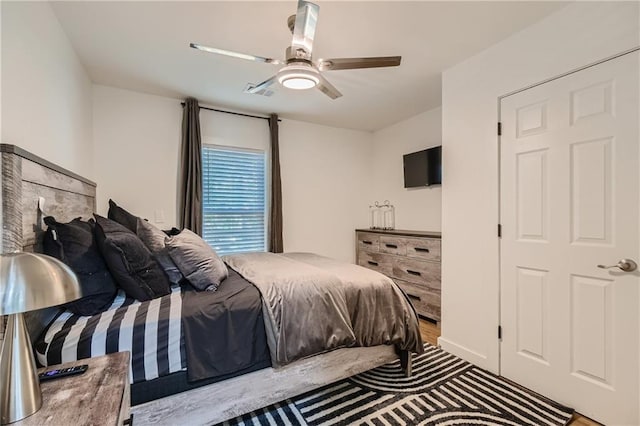 bedroom with ceiling fan and wood-type flooring