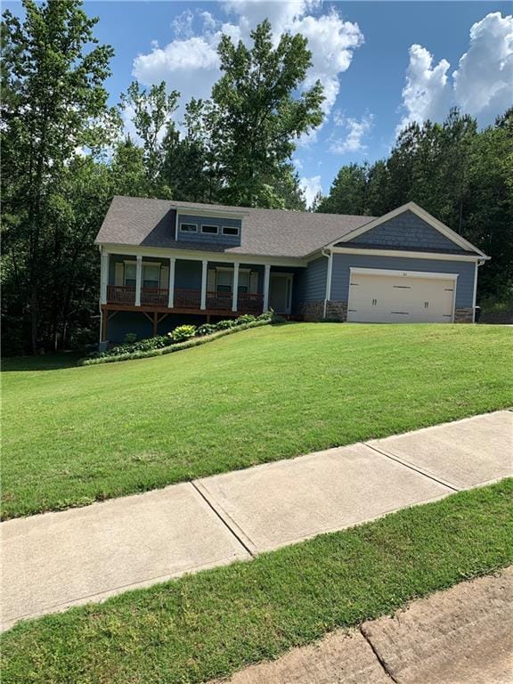 view of front of house featuring a garage and a front lawn