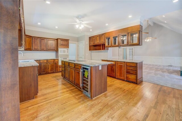 13935 Brown Bridge Rd, Covington, GA 30016 - kitchen featuring ceiling fan, white appliances, brown cabinets, a sink, and beverage cooler