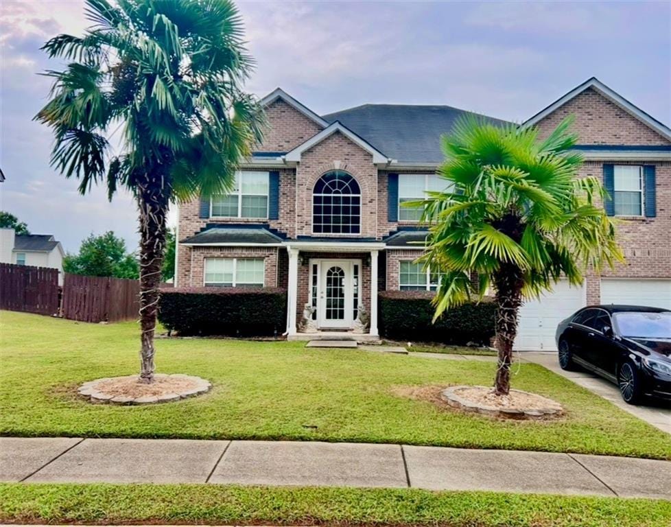 view of front of house featuring a garage and a front lawn