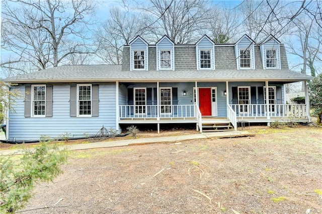 cape cod-style house with covered porch