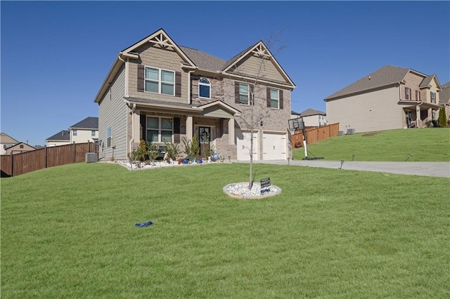 craftsman inspired home with central AC unit, a garage, and a front lawn