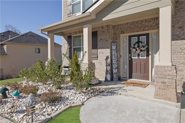 view of exterior entry featuring a porch