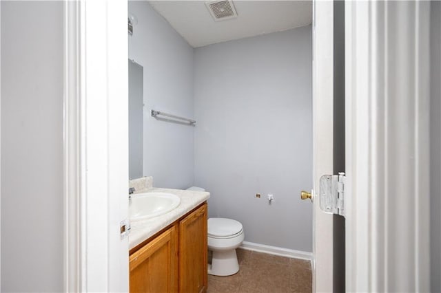 bathroom featuring toilet, vanity, and tile patterned flooring