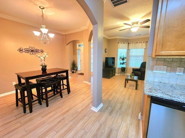 5449 Festival Ave, Fairburn, GA 30213 - dining room with arched walkways, light wood-type flooring, baseboards, ceiling fan, and ornamental molding
