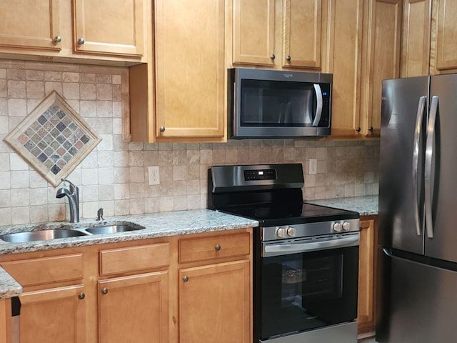 5449 Festival Ave, Fairburn, GA 30213 - kitchen featuring stainless steel appliances, a sink, backsplash, and light stone counters