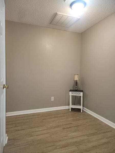 5449 Festival Ave, Fairburn, GA 30213 - empty room featuring wood finished floors, baseboards, and a textured ceiling
