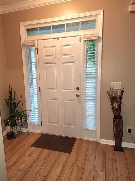 5449 Festival Ave, Fairburn, GA 30213 - entrance foyer with light wood-type flooring, crown molding, and baseboards