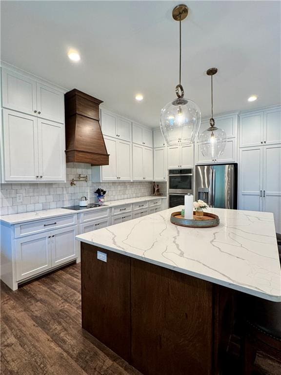 112 Three Oaks Dr SE, Calhoun, GA 30701 - kitchen featuring stainless steel appliances, custom range hood, dark wood-style floors, white cabinets, and recessed lighting