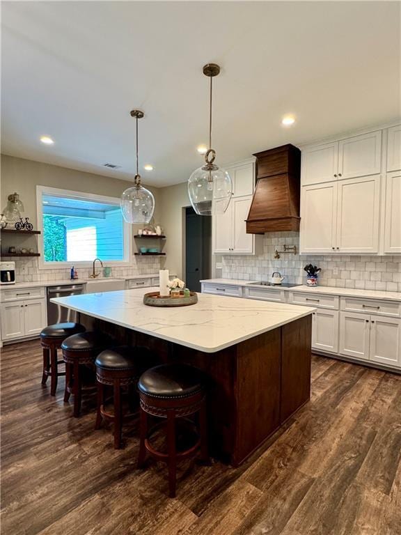 112 Three Oaks Dr SE, Calhoun, GA 30701 - kitchen with premium range hood, a kitchen island, backsplash, dishwasher, and white cabinets