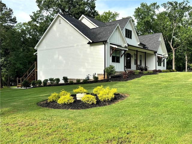 112 Three Oaks Dr SE, Calhoun, GA 30701 - view of home's exterior with roof with shingles, covered porch, a lawn, and board and batten siding