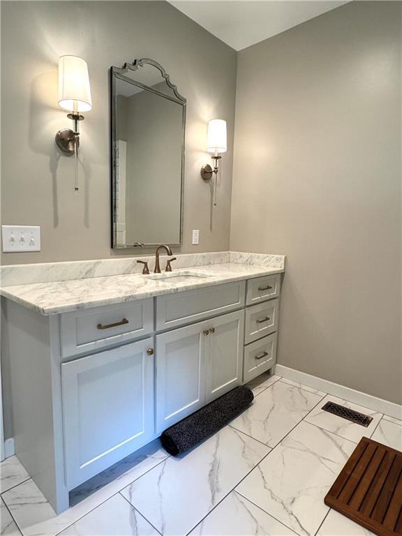 112 Three Oaks Dr SE, Calhoun, GA 30701 - bathroom featuring marble look tile flooring and vanity
