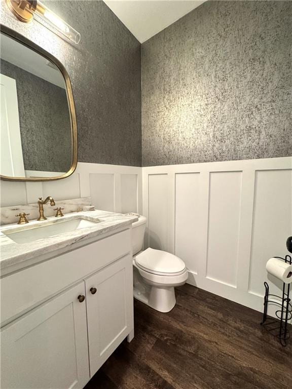 112 Three Oaks Dr SE, Calhoun, GA 30701 - bathroom featuring a decorative wall, wood finished floors, vanity, and a wainscoted wall