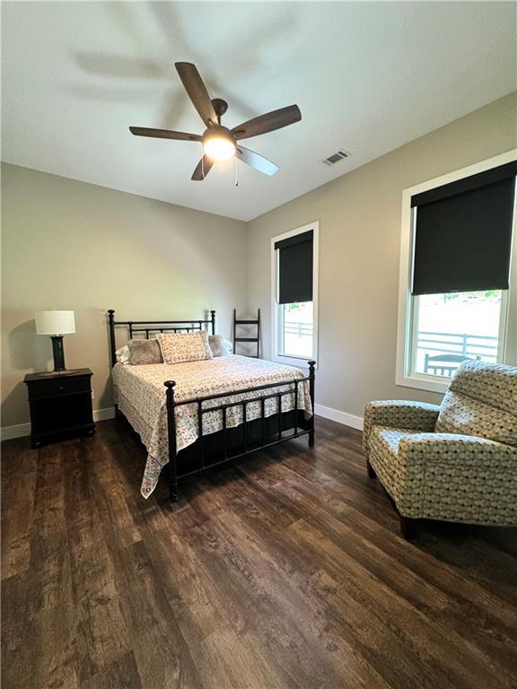 112 Three Oaks Dr SE, Calhoun, GA 30701 - bedroom with wood finished floors, multiple windows, and ceiling fan