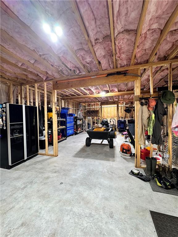 112 Three Oaks Dr SE, Calhoun, GA 30701 - garage with black fridge with ice dispenser