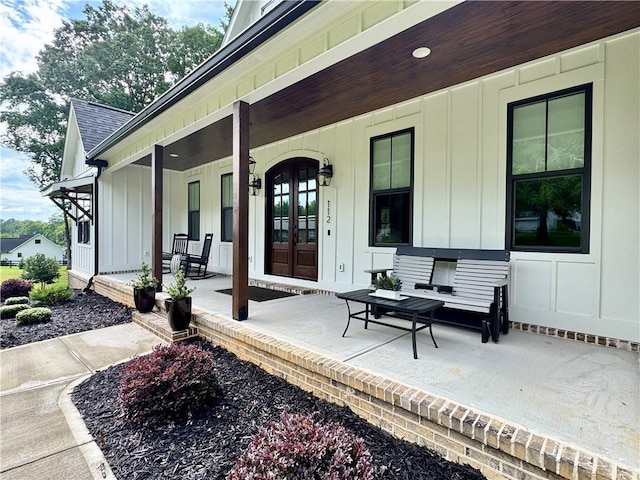 112 Three Oaks Dr SE, Calhoun, GA 30701 - entrance to property featuring board and batten siding, a porch, and a shingled roof