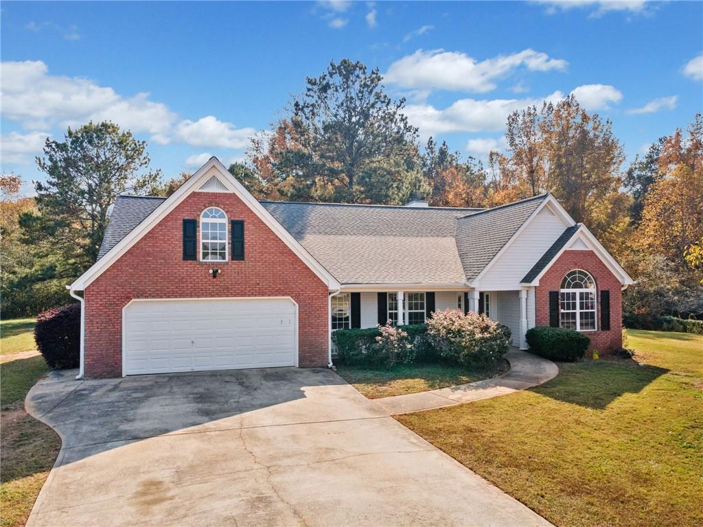 view of front of home with a garage and a front lawn