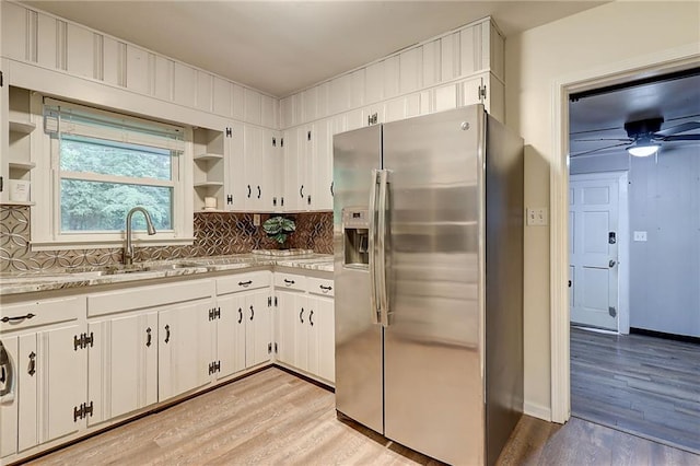 122 Vickery Dr, Fairburn, GA 30213 - kitchen featuring stainless steel refrigerator with ice dispenser, open shelves, a sink, and light wood-style floors