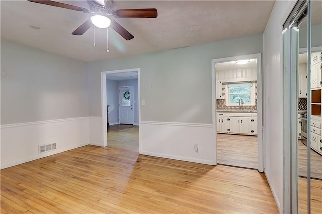 122 Vickery Dr, Fairburn, GA 30213 - empty room featuring a sink, light wood-type flooring, a ceiling fan, and baseboards