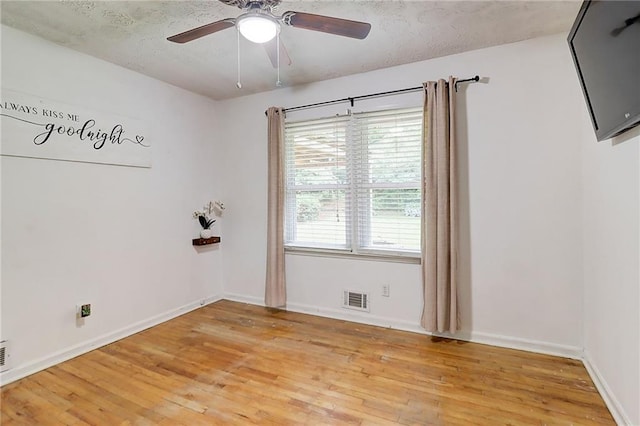 122 Vickery Dr, Fairburn, GA 30213 - spare room featuring light wood-type flooring, a ceiling fan, baseboards, and a textured ceiling