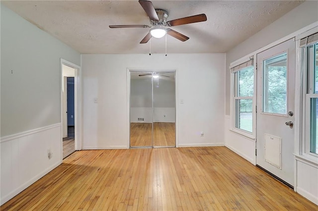 122 Vickery Dr, Fairburn, GA 30213 - empty room with light wood-style floors, a ceiling fan, a textured ceiling, and baseboards